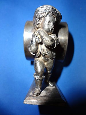   CO. #155 , NAPKIN RING OF A YOUNG BOY CARRYING HOLDER ON BACK BY ROPE