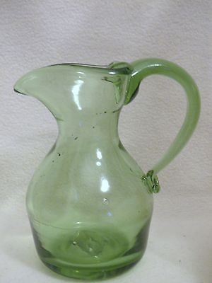 https://7ce66355b3fb4084b2bf-5faf2a66ff94ef5fcf3b9108acd7d2cf.ssl.cf1.rackcdn.com/156523625_vintage-green-glass-pitcher-in-glassware.jpg