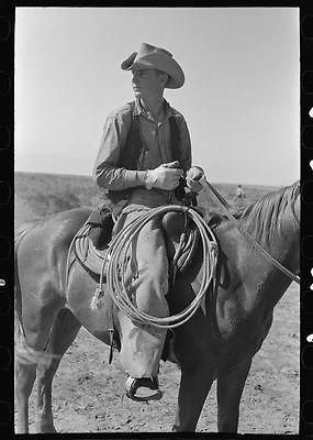 PhotoCowboy on horse with equipment on cattle ranch near Spur,Texas